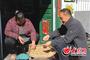 　丰德玉(右)在村民李华家中走访