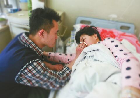 22日，山东省立医院病房，丈夫张良峰在照顾患病的王兆红。 见习记者刘玉乐 摄