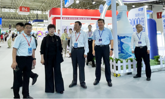 中国奶业协会原副会长兼秘书长刘亚清(左二)视察得益乳业展位