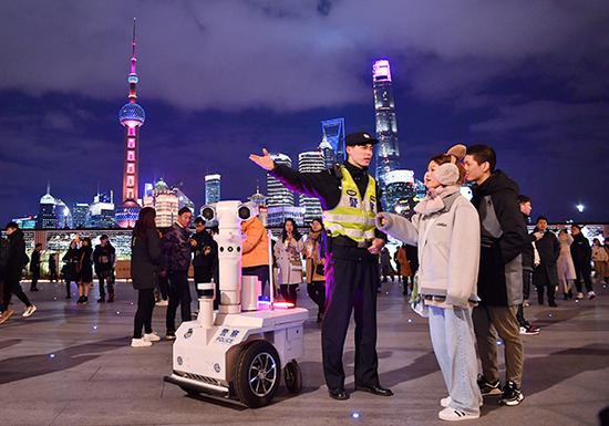 跨年夜,上海外滩,民警为市民游客服务。