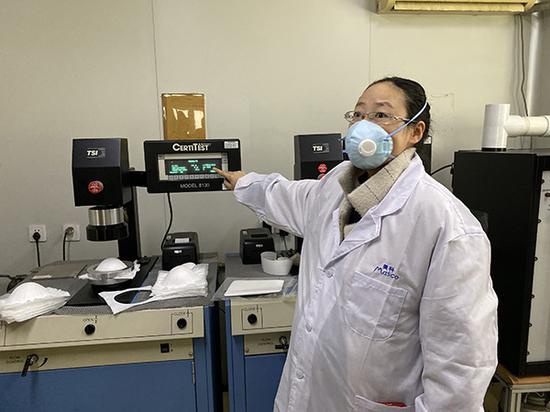 上海港凯的技术负责人王艳正在实验室里检测KN95口罩的吸气阻力、过滤效率等指标。