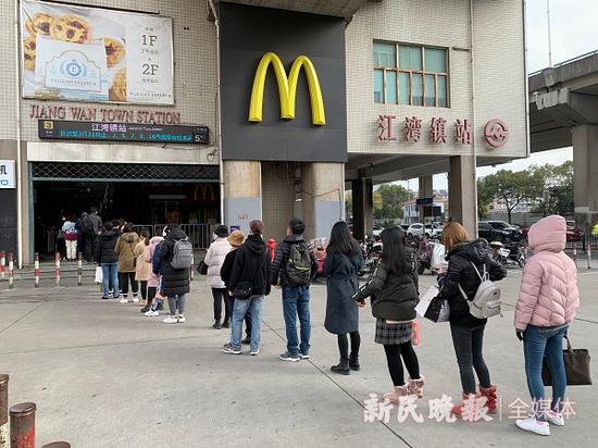 图说:江湾镇站5号出入口外,十多名乘客正有序排队进入南站厅 曹刚 摄