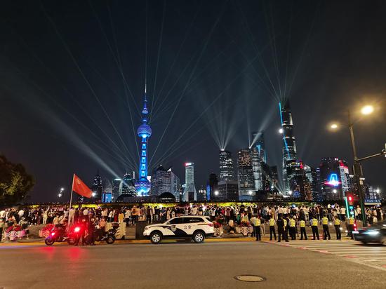 9月30日晚，上海外滩再现超大客流，黄浦警方组成拉链式人墙维护秩序。