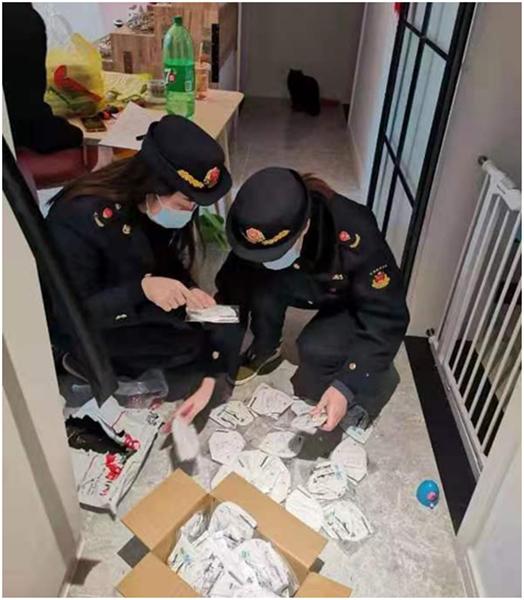 图说:虹口区市场监管局在唐某家中发现,其经营的口罩无法提供营业执照