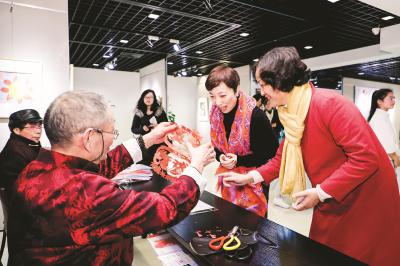 蔡氏剪纸技艺传承人蔡德福展示剪纸技艺,与市民一同欢度春节。 (宝山区文广影视局供图)
