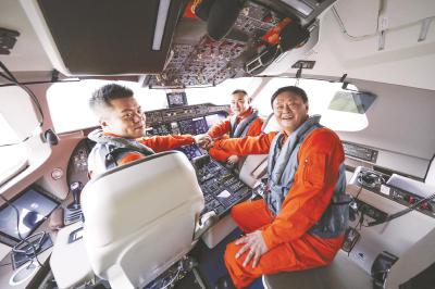 图为钱进(右一)与其试飞机组团队成员。(中国商飞供图)
