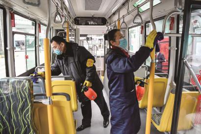 49路公交车的消毒员正在为到站的车辆进行全面消毒。本报记者 陈龙摄