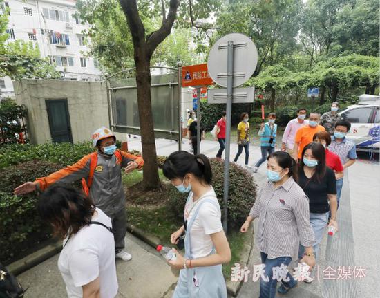 图说:居民听到警报后进入应急避难场所。张龙 摄