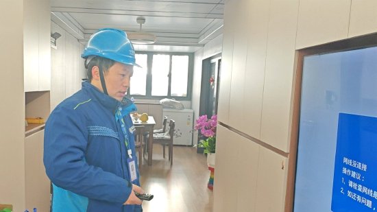 图说：爱家工程师小汝在用户家中调测网络。