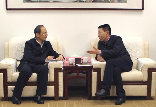 山西证监局局长孙才仁(右)与忻州市市长郑连生进行交流