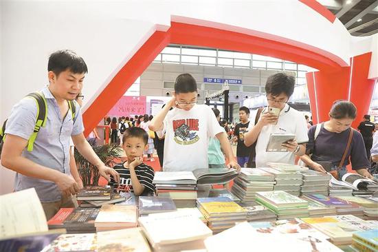 ▲大人小孩一起挑选书籍。深圳晚报记者 杨少昆 摄