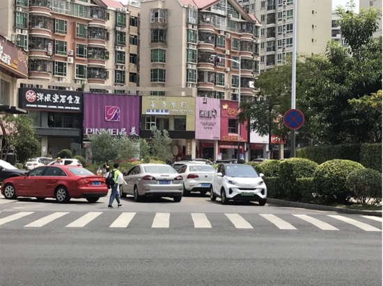 21日中午,富瑰路与宝民二路交叉路口处,在禁停标识牌下,仍有不少车辆违停。