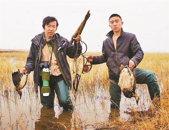 ▲中国野生动物保护协会科学考察委员会副主任周海翔（图左）在实施排查捕夹工作。 中国野生动物保护协会供图