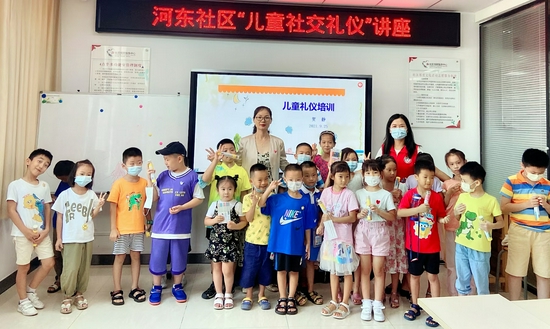 孩子带上礼仪勋章跟老师、社工合影