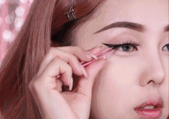 将暗粉色眼影涂抹于眼尾及下眼线后半部分~ 把红棕色眼影涂抹在眼尾