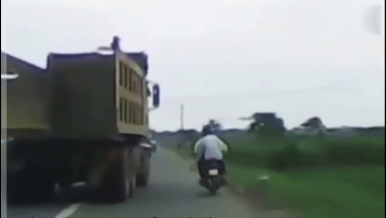 摩托车想超卡车，结果两者相撞
