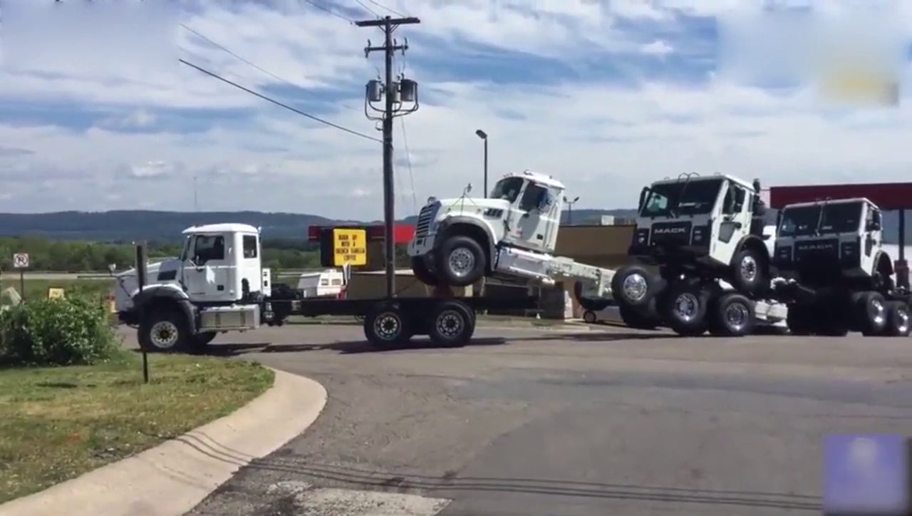 美国卡车新车发货，采用半背半拖的方式运输