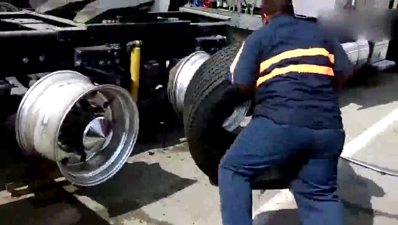实拍工人给新的卡车安装轮胎 没力气干不了这活儿
