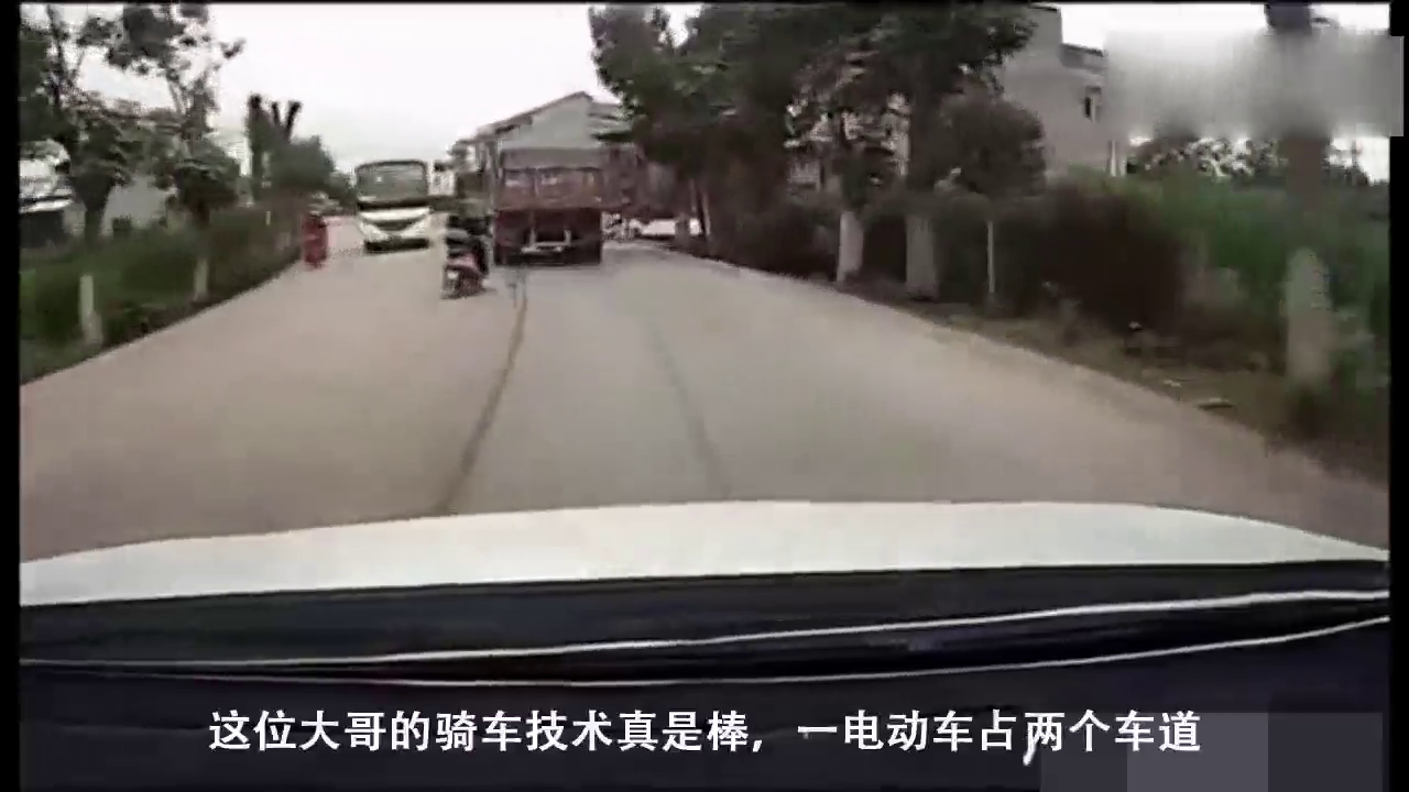 这位大哥的骑车技术真是棒，一电动车占两个车道！