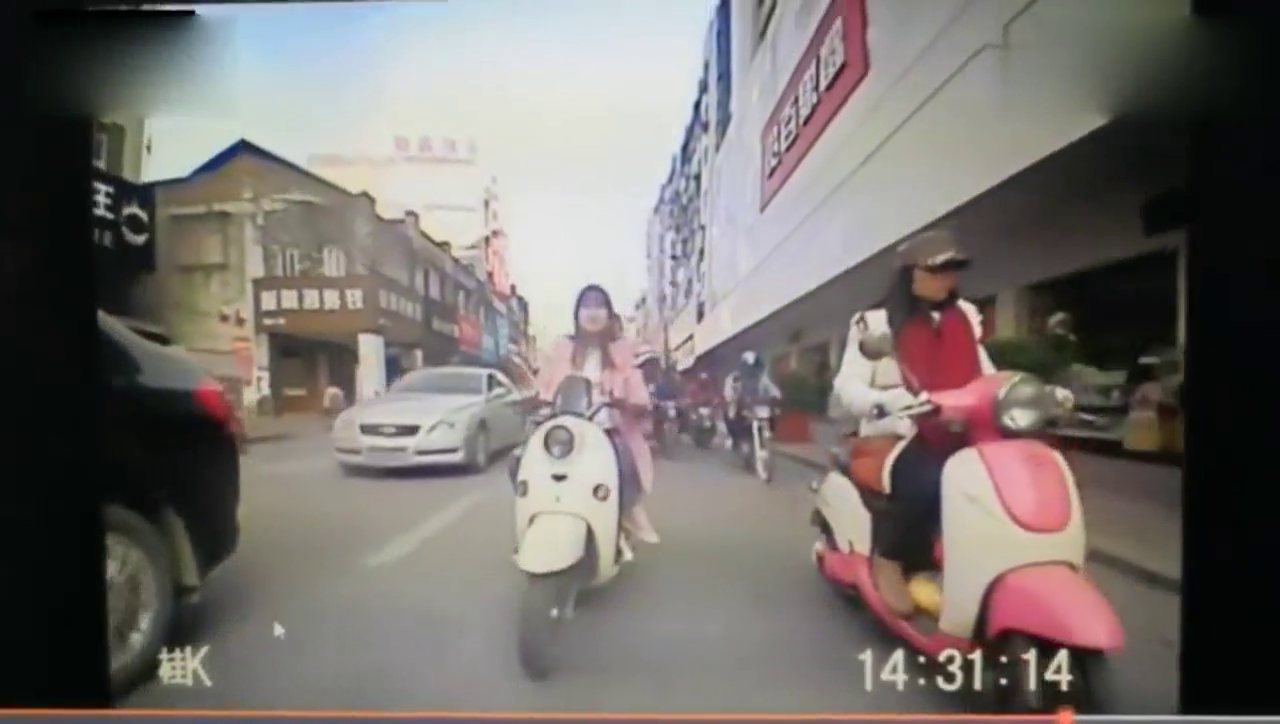 电动车女司机面不改色，追尾轿车后溜之大吉