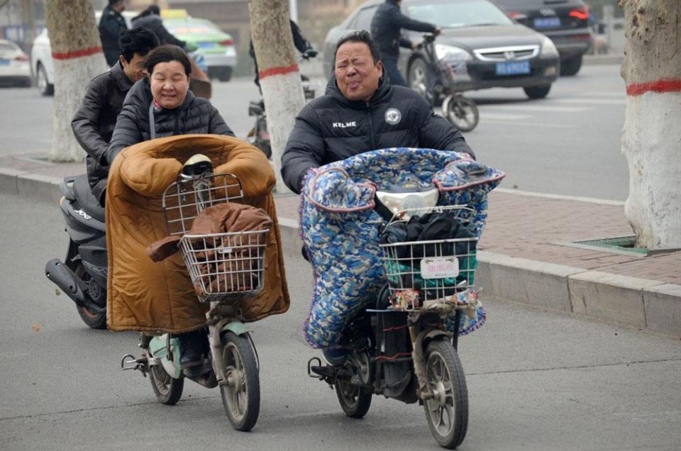 在街头,市民顶风出行.