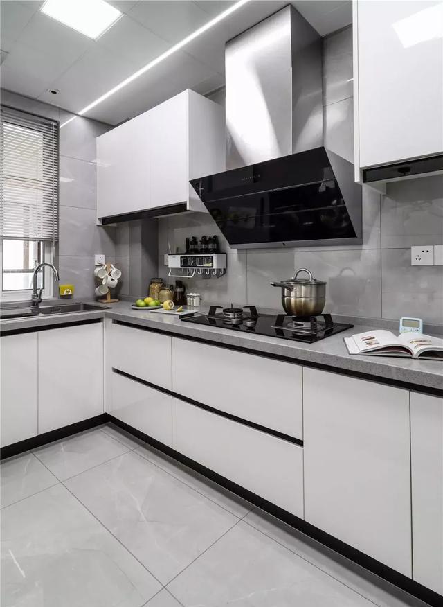 厨房以灰色为主基调,搭配白色一体式的橱柜设计,提升了整个空间的洁净