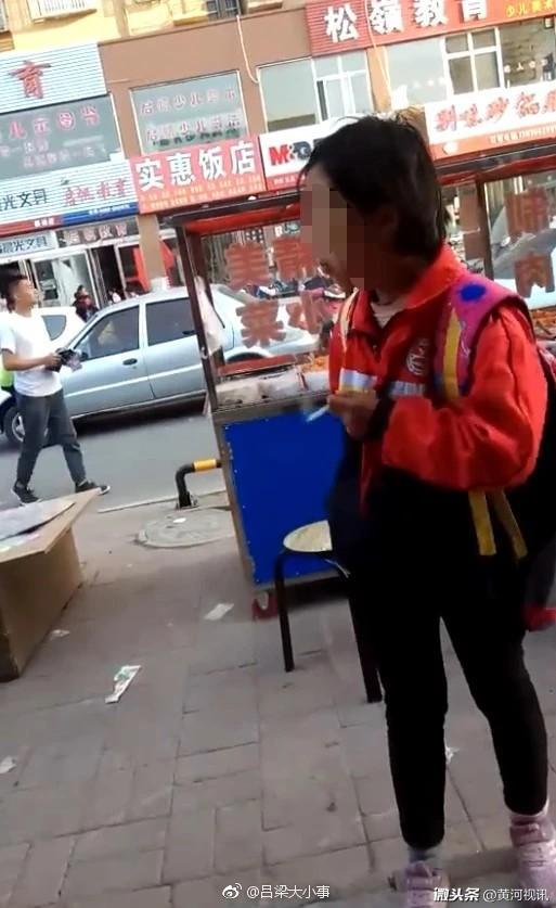 网友在山西晋城 街头碰见一名戴红领巾的小女孩在抽烟