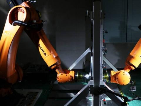 日产公司研发两个机器人面对面工作 一次性制造汽车零配件