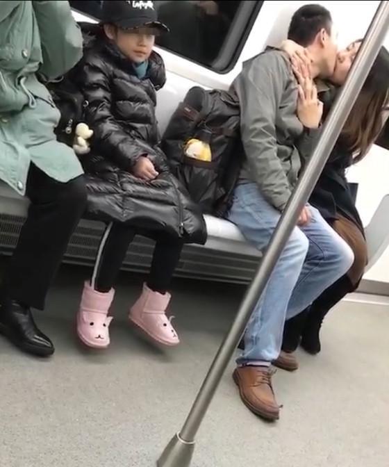 情侣地铁上激情热吻 旁边小女孩面部表情极尴尬
