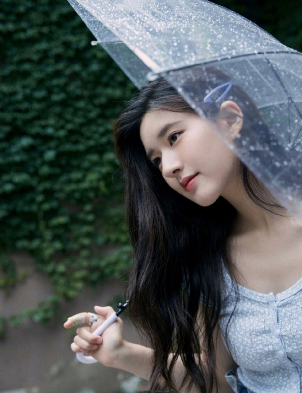赵露思分享的一组打伞在雨中的照片,整体造型简洁具有