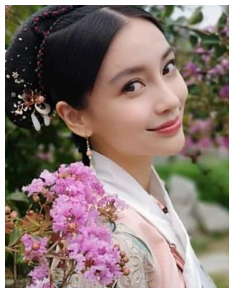 的发型和精致的妆容搭配,使她整个人看起来美如画中走出的女人一般