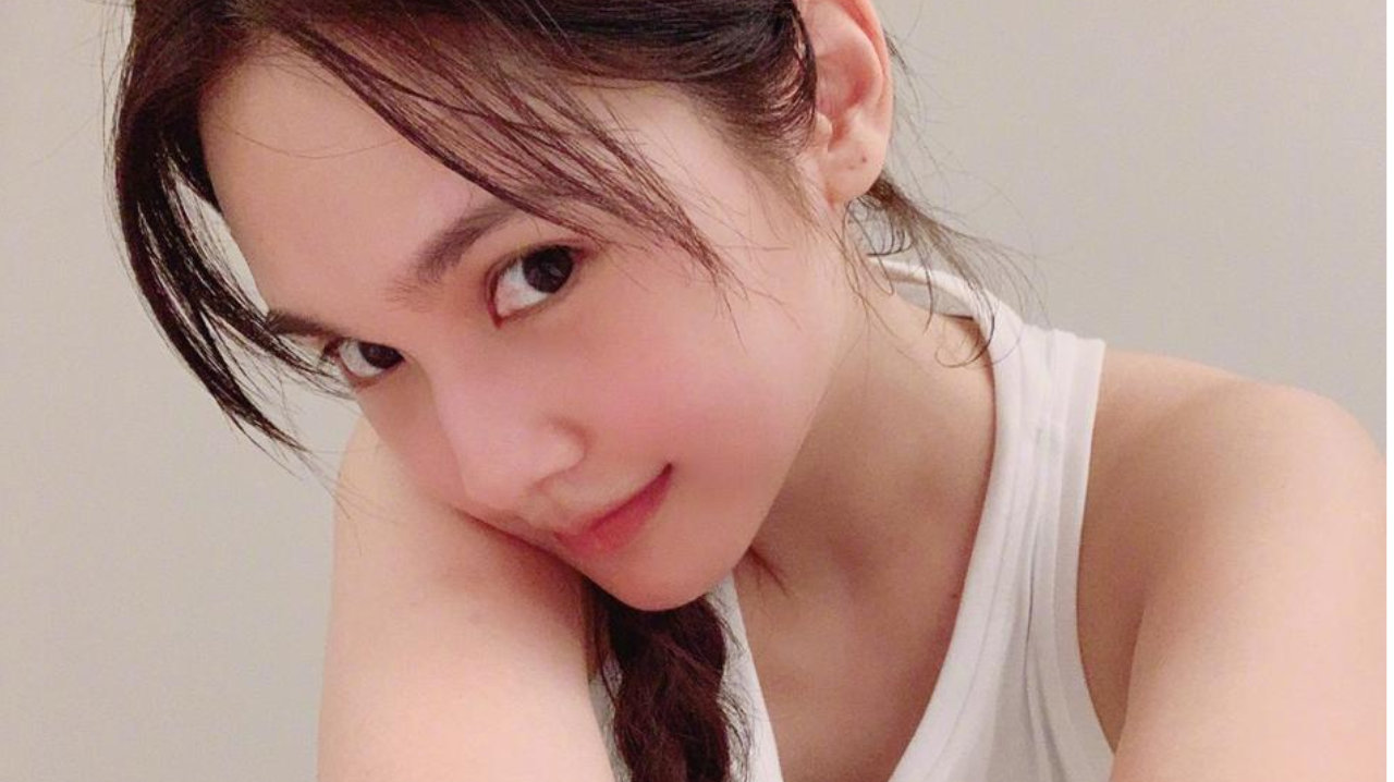 杨丞琳穿着白色运动背心，渗着汩汩香汗