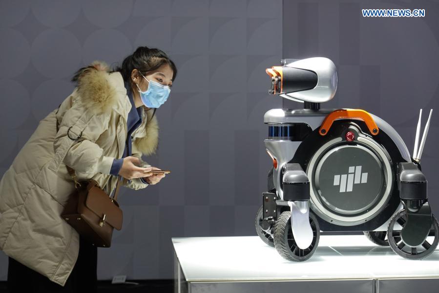 A visitor views a smart inspection robot at an industrial design exhibition during the 2020 World Industrial Design Conference in Yantai, east China's Shandong Province, Nov. 25, 2020. The 2020 World Industrial Design Conference is held from Nov. 25 to 29 in Yantai. The conference also includes an exposition of China's top industrial designs, with over 800 domestic companies showcasing over 1,000 exhibits of new technology, new design and new products. (Photo by Tang Ke/Xinhua)