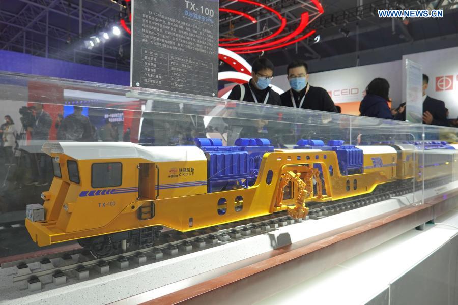 Visitors view the model of a TX-100 rail roadbed suction sewage truck at an industrial design exhibition during the 2020 World Industrial Design Conference in Yantai, east China's Shandong Province, Nov. 25, 2020. The 2020 World Industrial Design Conference is held from Nov. 25 to 29 in Yantai. The conference also includes an exposition of China's top industrial designs, with over 800 domestic companies showcasing over 1,000 exhibits of new technology, new design and new products. (Photo by Tang Ke/Xinhua)