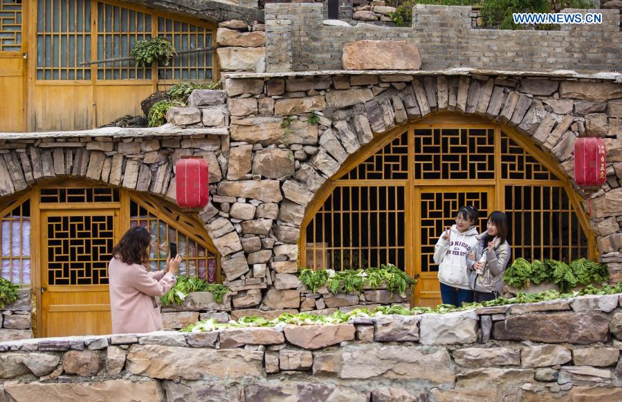 Visitors tour a traditional residence at Huoshui Town in Wuan, north China's Hebei Province, Nov. 26, 2020. In recent years, based on its advantages of rural resources, Wuan City has built traditional villages with local characteristics to develop rural tourism. (Xinhua/Zhu Xudong)