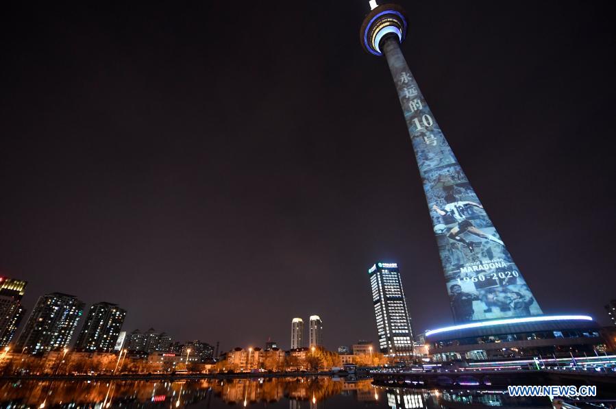 The image of football legend Diego Maradona is projected on Tianjin TV Tower in north China's Tianjin Municipality, Nov. 26, 2020. Maradona died at the age of 60 on Wednesday of a heart attack. (Xinhua/Li Ran)