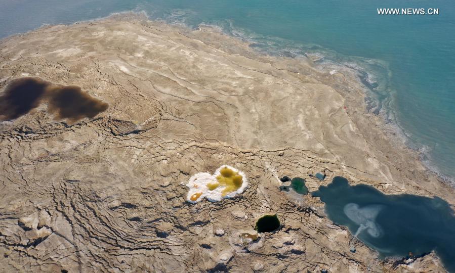 Sinkholes are seen on the shore of the Dead Sea near Ein Gedi beach on Nov. 28, 2020. As the Dead Sea is shrinking and its water levels decreasing, hundreds of sinkholes are devouring land where the shoreline once stood. (Photo by Gil Cohen Magen/Xinhua)