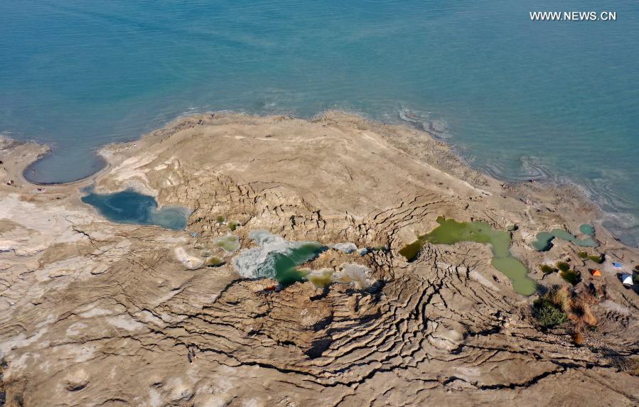 Sinkholes are seen on the shore of the Dead Sea near Ein Gedi beach on Nov. 28, 2020. As the Dead Sea is shrinking and its water levels decreasing, hundreds of sinkholes are devouring land where the shoreline once stood. (Photo by Gil Cohen Magen/Xinhua)