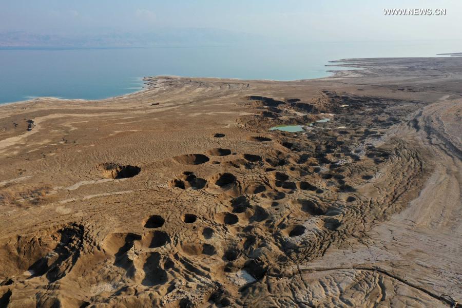 Sinkholes are seen on the shore of the Dead Sea near Ein Gedi beach on Nov. 28, 2020. As the Dead Sea is shrinking and its water levels decreasing, hundreds of sinkholes are devouring land where the shoreline once stood. (Photo by Gil Cohen Magen/Xinhua)