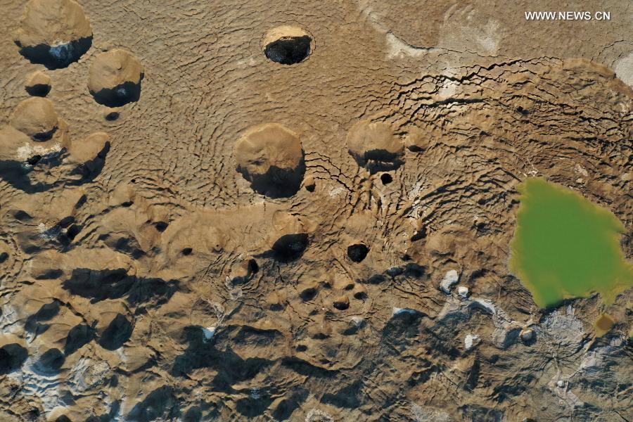 Sinkholes are seen on the shore of the Dead Sea near Ein Gedi beach on Nov. 28, 2020. As the Dead Sea is shrinking and its water levels decreasing, hundreds of sinkholes are devouring land where the shoreline once stood. (Photo by Gil Cohen Magen/Xinhua)