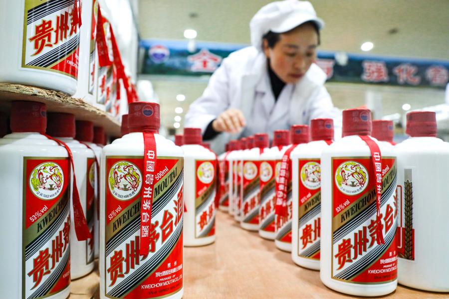 A worker conducts packaging works at a distillery in Maotai town of Renhuai, southwest China's Guizhou Province, Nov. 27, 2020. Maotai is a small town in Renhuai City in mountainous Guizhou. What distinguishes it from other towns is that it produces a famous brand of Chinese liquor Moutai. The spirit, made from sorghum and wheat, takes up to one year for the whole production process, involving nine times of steaming, eight times of fermentation and seven times of distillation, before aged in clay pots. (Xinhua/Ou Dongqu)