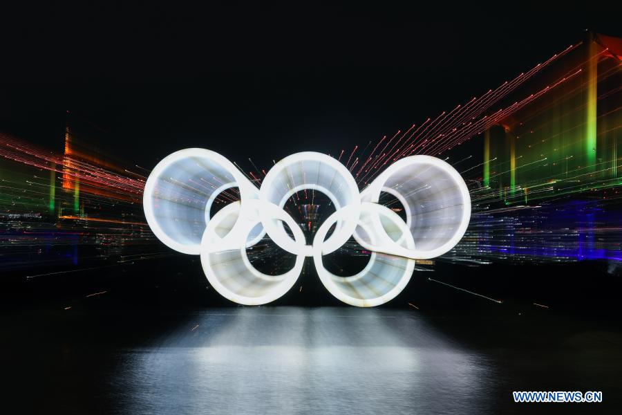 The illuminated Olympic rings, Rainbow Bridge and Tokyo Tower are seen at Tokyo Bay area, in Tokyo, Japan, Dec. 1, 2020. The giant Olympic rings returned to Tokyo Bay here on Tuesday about four months after being removed for safety and maintenance checks. The Rainbow Bridge is specially illuminated in rainbow colors. (Xinhua/Du Xiaoyi)