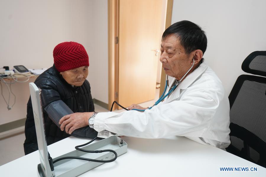 A medical worker checks blood pressure for a senior woman at a community elderly care center at the Suzhou Industrial Park in Suzhou, east China's Jiangsu Province, Dec. 1, 2020. The elderly care center recently welcomed its clients back upon completion of a two-year renovation project that had fundamentally upgraded this facility from an ordinary nursing home. A professional management and operation team was also introduced to ensure quality services to the senior people living there. (Xinhua/Ji Chunpeng)