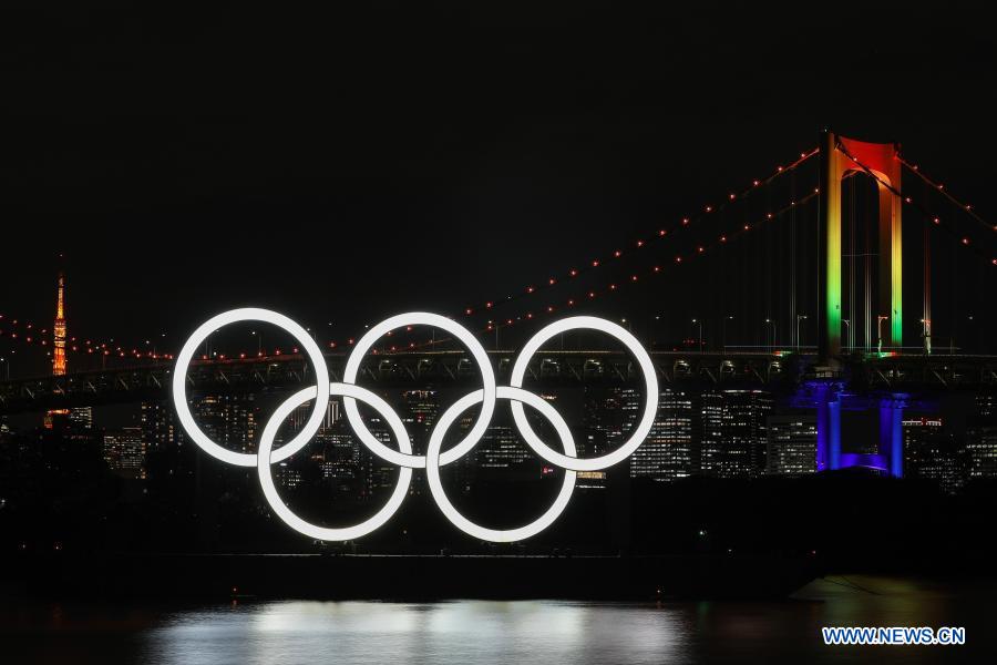 The illuminated Olympic rings, Rainbow Bridge and Tokyo Tower are seen at Tokyo Bay area, in Tokyo, Japan, Dec. 1, 2020. The giant Olympic rings returned to Tokyo Bay here on Tuesday about four months after being removed for safety and maintenance checks. The Rainbow Bridge is specially illuminated in rainbow colors. (Xinhua/Du Xiaoyi)