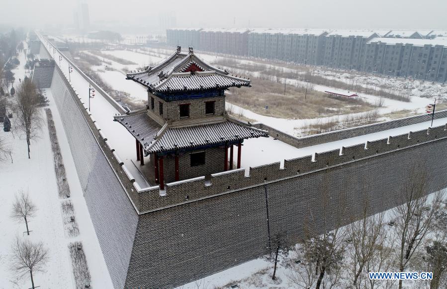 Photo taken on Dec. 6, 2020 shows a view of snow-covered Xuanhua ancient city in Zhangjiakou, north China's Hebei Province. (Photo by Chen Xiaodong/Xinhua)