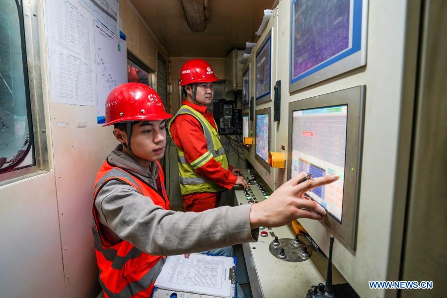 Engineers work in an operation room of a shield tunneling machine at the construction site of Suzhou Subway Line S1 in Suzhou, east China's Jiangsu Province, Dec. 7, 2020. The Suzhou Subway Line S1 with a total length of 41.25 kilometers is expected to be put into trial operation in December 2023. (Xinhua/Li Bo)
