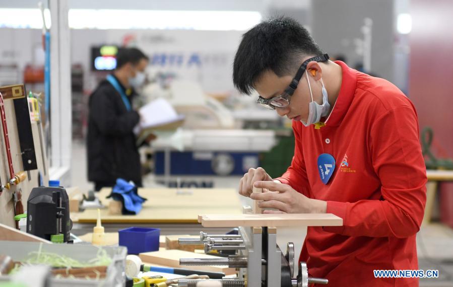 A contestant takes part in a woodworking contest during the first vocational skills competition in Guangzhou, south China's Guangdong Province, Dec. 10, 2020. The competition, running from Thursday to Sunday, will see over 2,500 contestants taking part in 86 catogories of contests. (Xinhua/Lu Hanxin)
