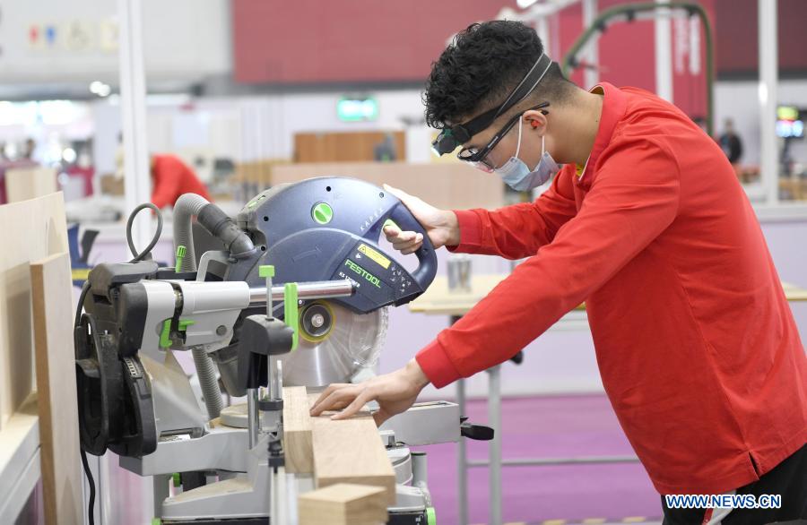 A contestant cuts wood during the first vocational skills competition in Guangzhou, south China's Guangdong Province, Dec. 10, 2020. The competition, running from Thursday to Sunday, will see over 2,500 contestants taking part in 86 catogories of contests. (Xinhua/Lu Hanxin)