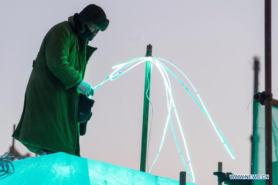 A worker works at a construction site for the Harbin Ice-Snow World, a renowned seasonal theme park opening every winter, in Harbin, northeast China's Heilongjiang Province, Dec. 14, 2020. The 22nd Harbin Ice-Snow World is expected to open in late December. (Xinhua/Xie Jianfei)