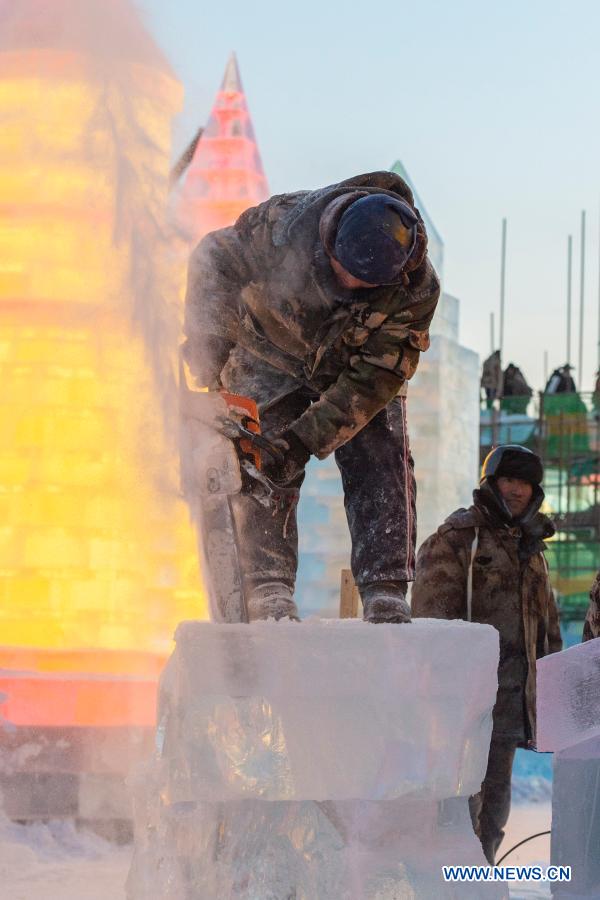 Workers work at a construction site for the Harbin Ice-Snow World, a renowned seasonal theme park opening every winter, in Harbin, northeast China's Heilongjiang Province, Dec. 14, 2020. The 22nd Harbin Ice-Snow World is expected to open in late December. (Xinhua/Xie Jianfei)